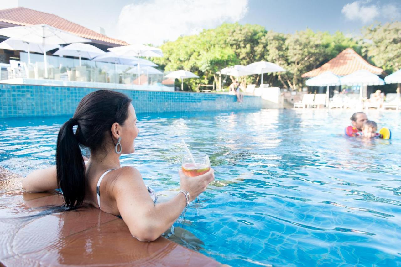 Hotel The Capital Zimbali Ballito Esterno foto A woman relaxing at a pool